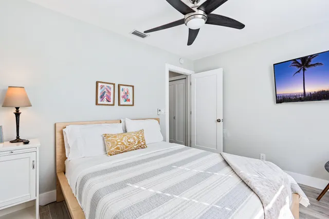 a bedroom with a bed and a lamp