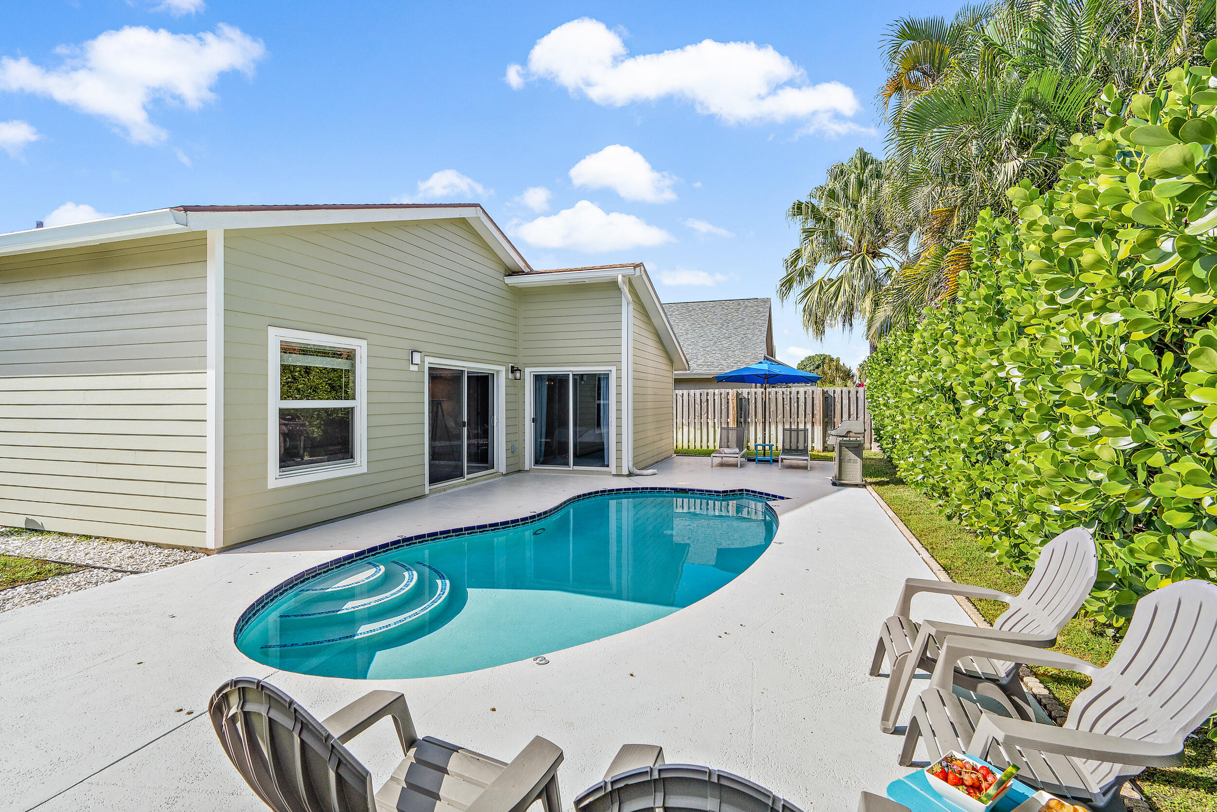 6219 Linton Street Jupiter, FL 33458 - Photo 21 of 41 a view of a house with pool fire pit and chairs in the patio