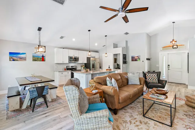 a living room with furniture and kitchen view