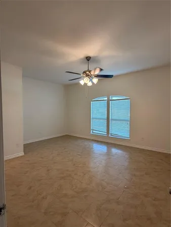 a bathroom with a granite countertop bathtub shower sink vanity and toilet