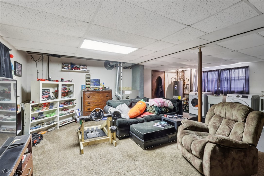 6370 Trumbull Road Geneva, OH 44041 - Photo 26 of 50 Carpeted living room with a drop ceiling, separate washer and dryer, and electric water heater