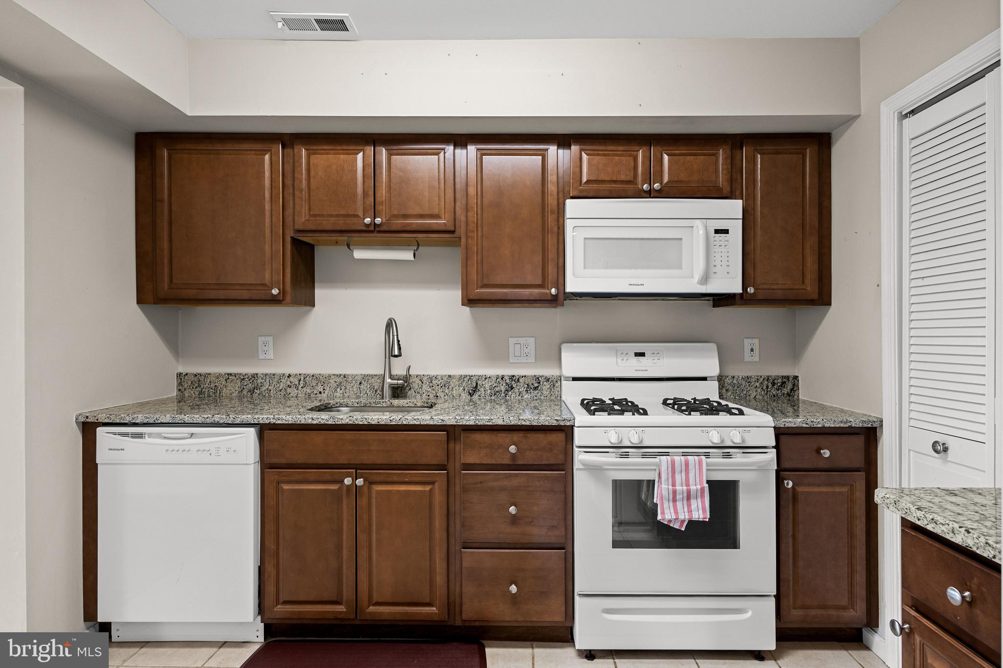 3704 Fenwick Lane Mount Laurel, NJ 08054 - Photo 12 of 26 a kitchen with granite countertop cabinets stove and microwave