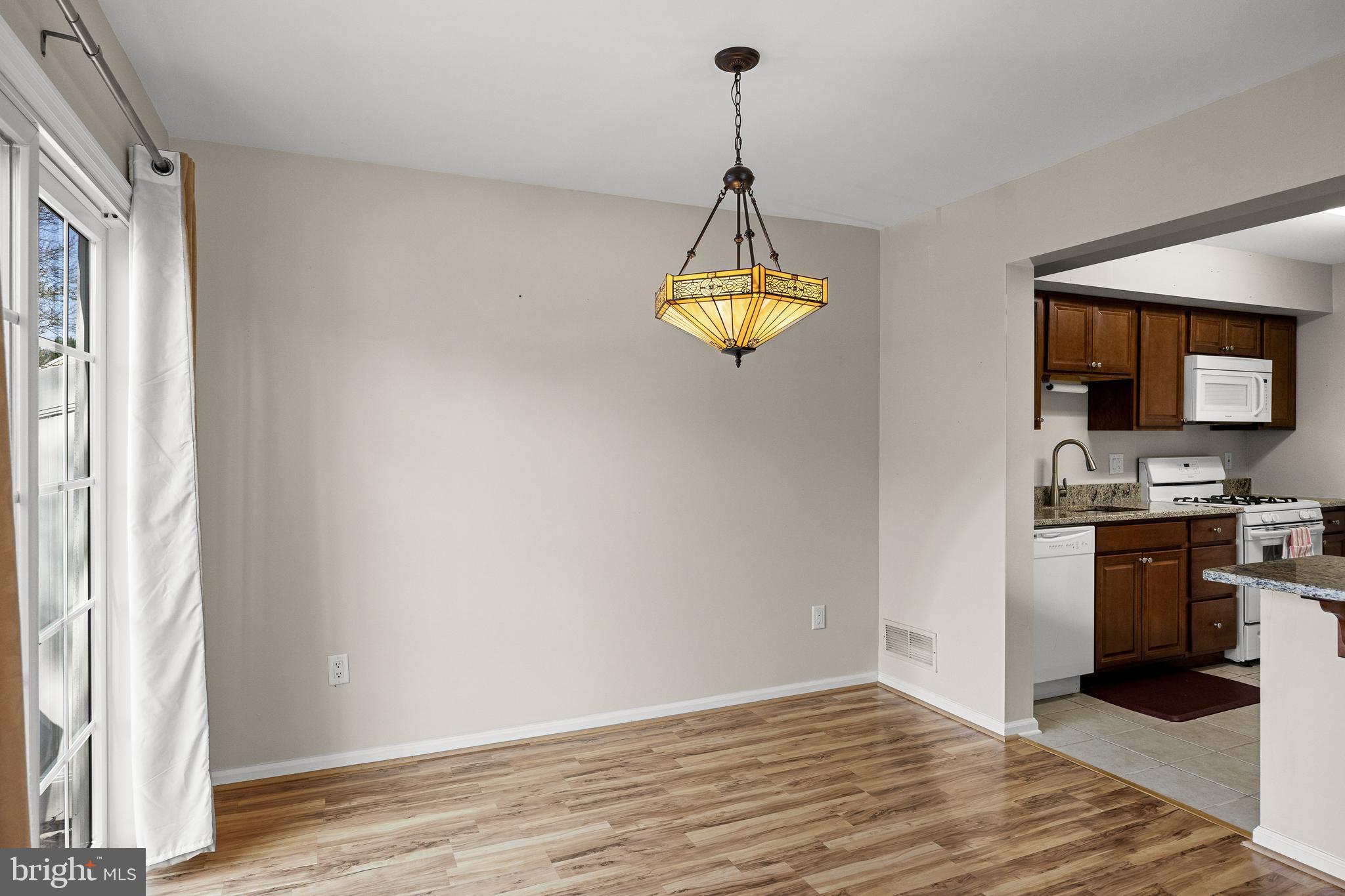 3704 Fenwick Lane Mount Laurel, NJ 08054 - Photo 9 of 26 a view of a kitchen with a stove and a wooden floor
