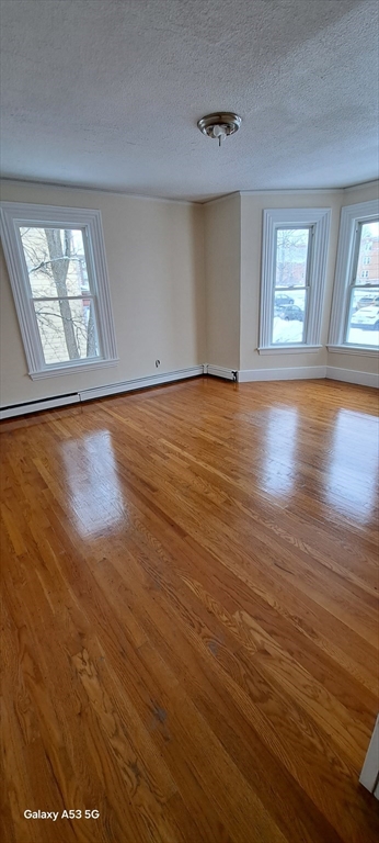 16 Bowdoin Street, Unit 2 Worcester, MA 01609 - Photo 11 of 13 wooden floor in an empty room with a window
