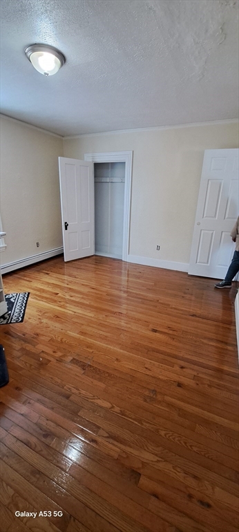 16 Bowdoin Street, Unit 2 Worcester, MA 01609 - Photo 9 of 13 an empty room with wooden floor and windows