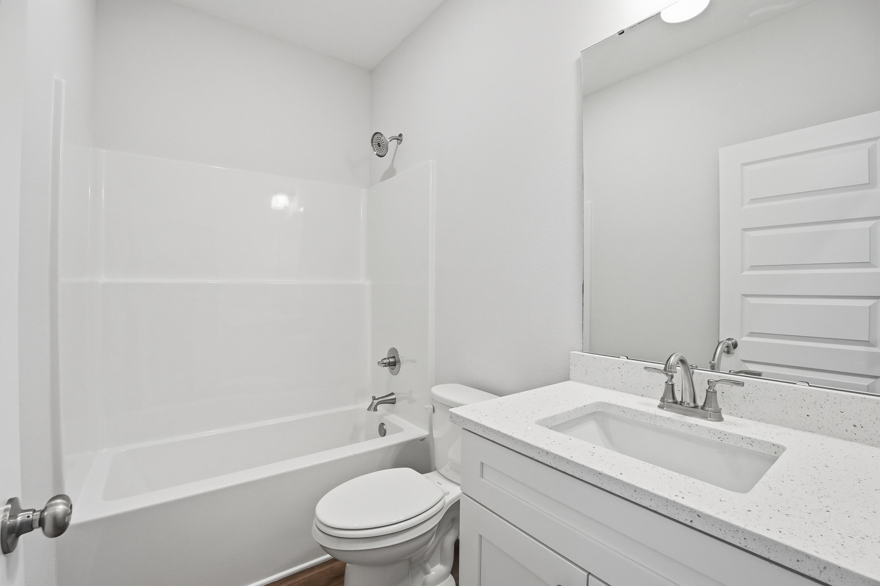 6194 Winstead Cove Crestview, FL 32539 - Photo 12 of 17 a bathroom with a granite countertop toilet a sink and a bathtub