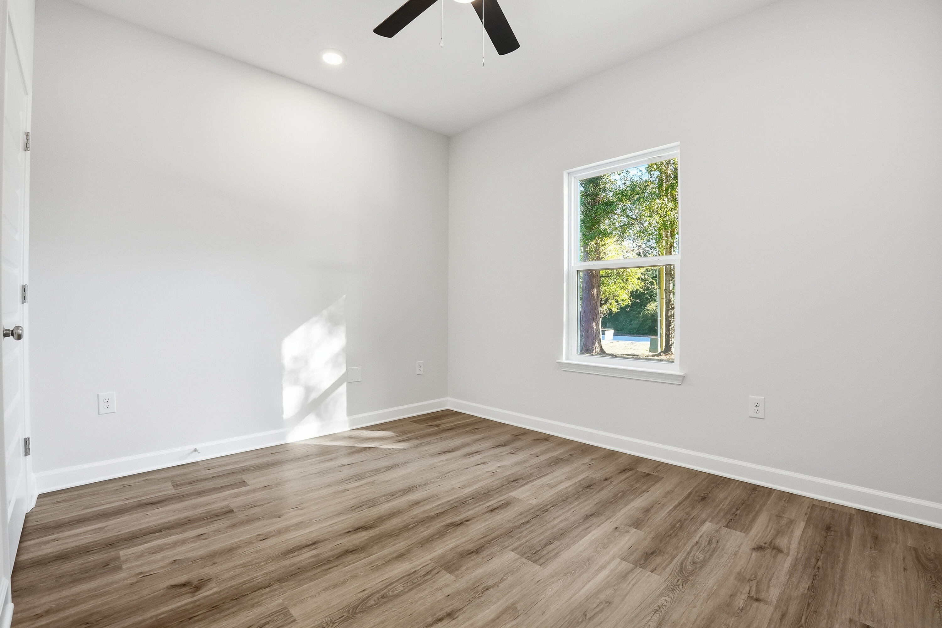 6194 Winstead Cove Crestview, FL 32539 - Photo 13 of 17 wooden floor in an empty room with a window