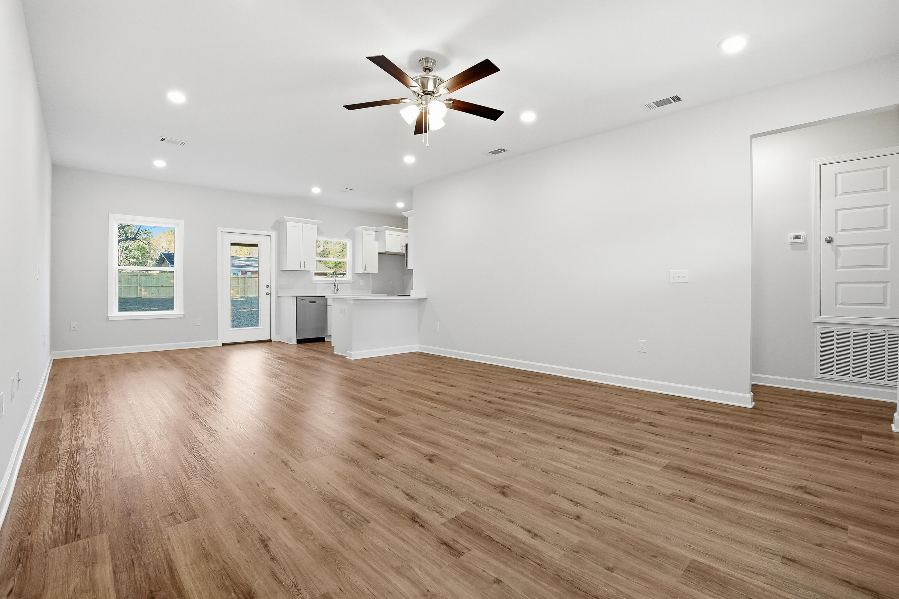 6194 Winstead Cove Crestview, FL 32539 - Photo 3 of 17 an empty room with wooden floor and windows