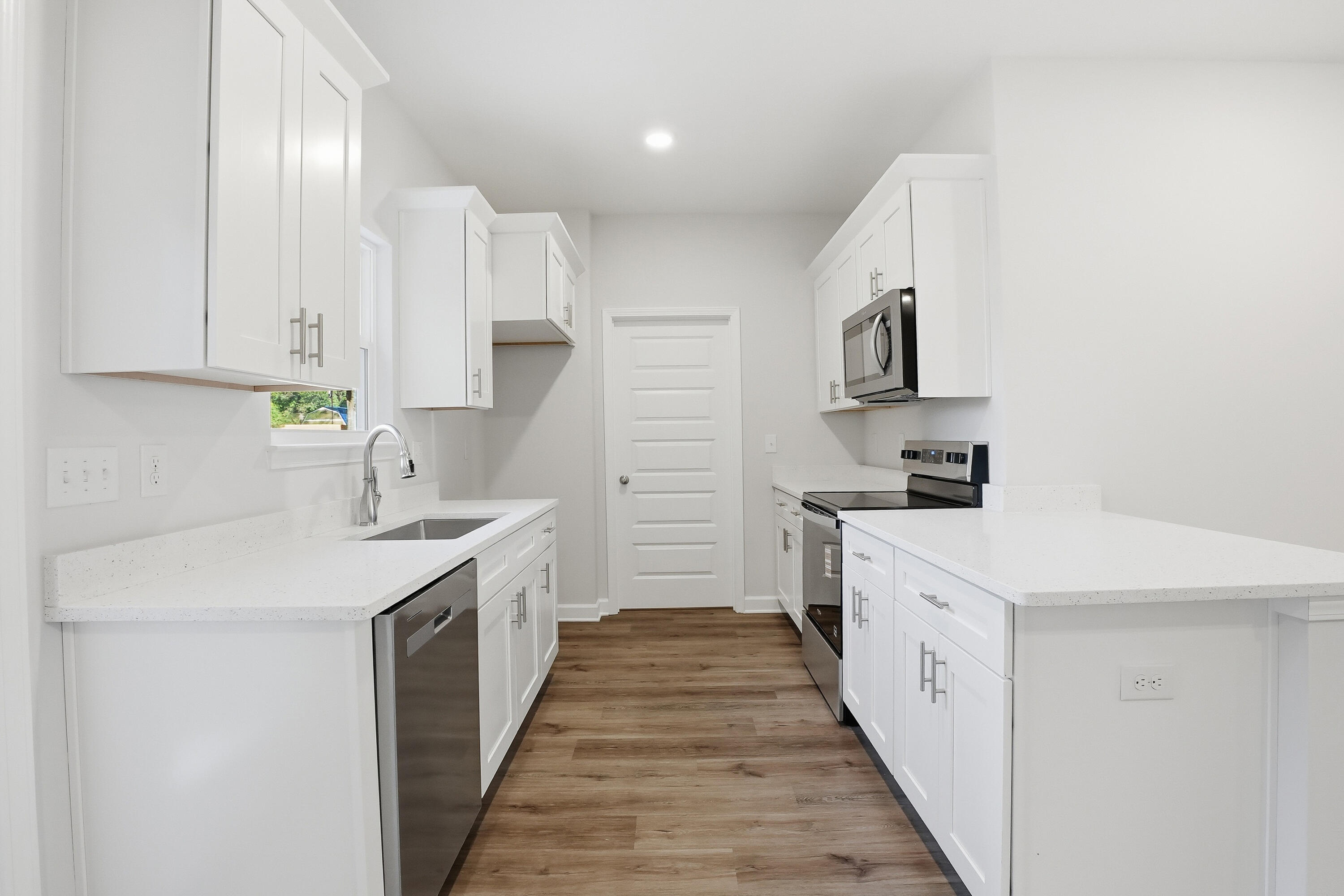 6194 Winstead Cove Crestview, FL 32539 - Photo 6 of 17 a kitchen with white cabinets appliances and sink
