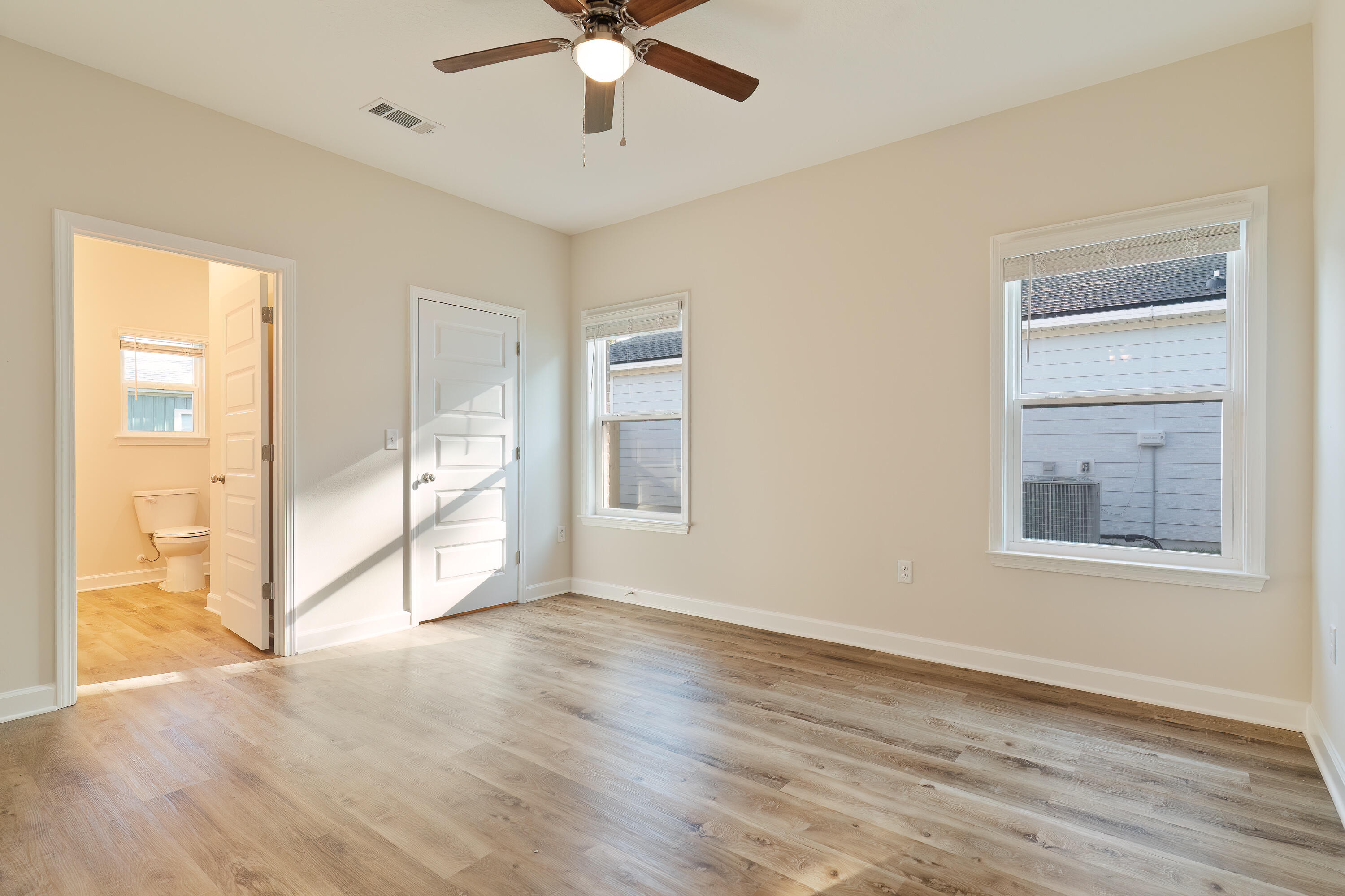 6194 Winstead Cove Crestview, FL 32539 - Photo 8 of 15 an empty room with wooden floor fan and windows
