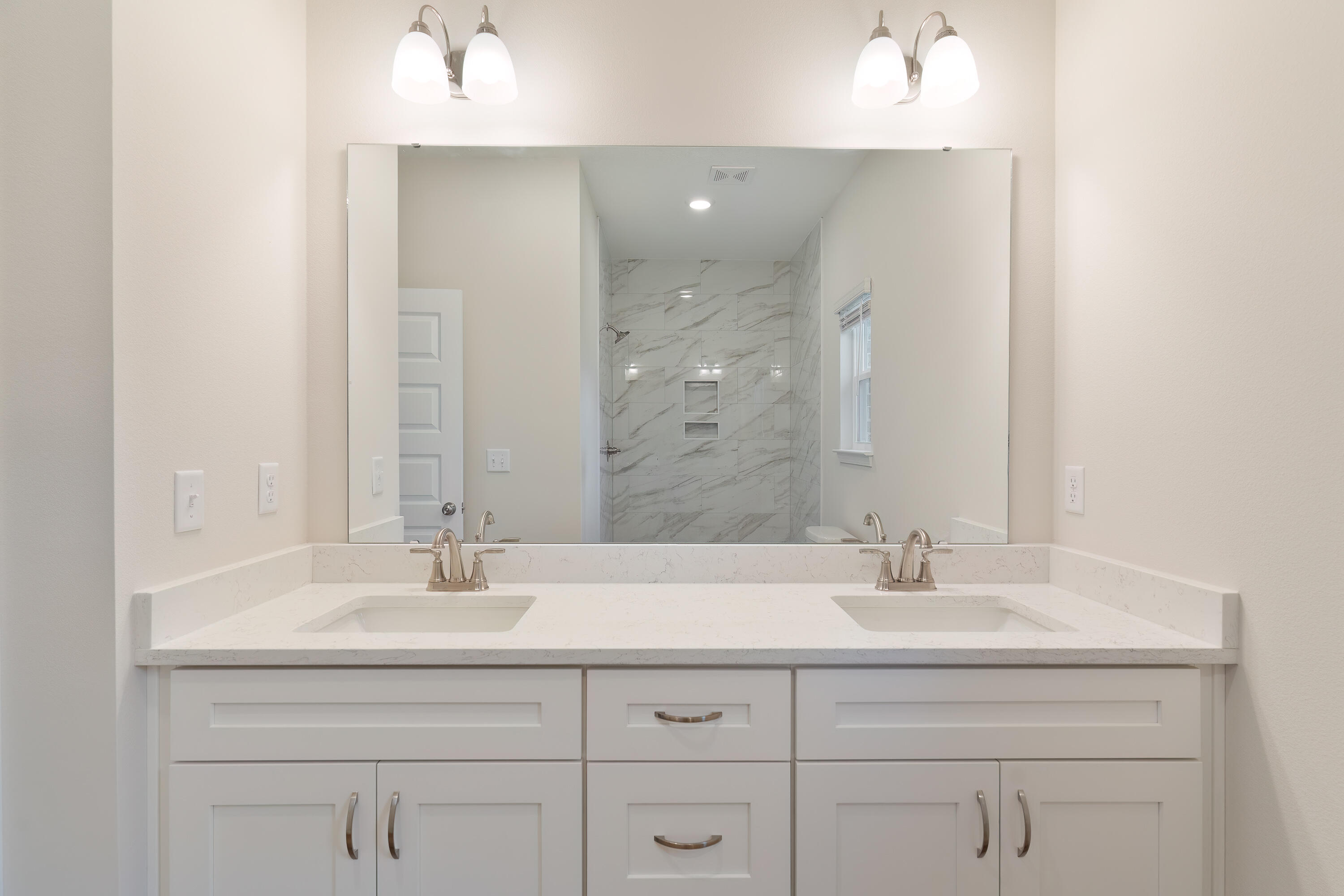 6194 Winstead Cove Crestview, FL 32539 - Photo 10 of 15 a bathroom with double sink and a mirror