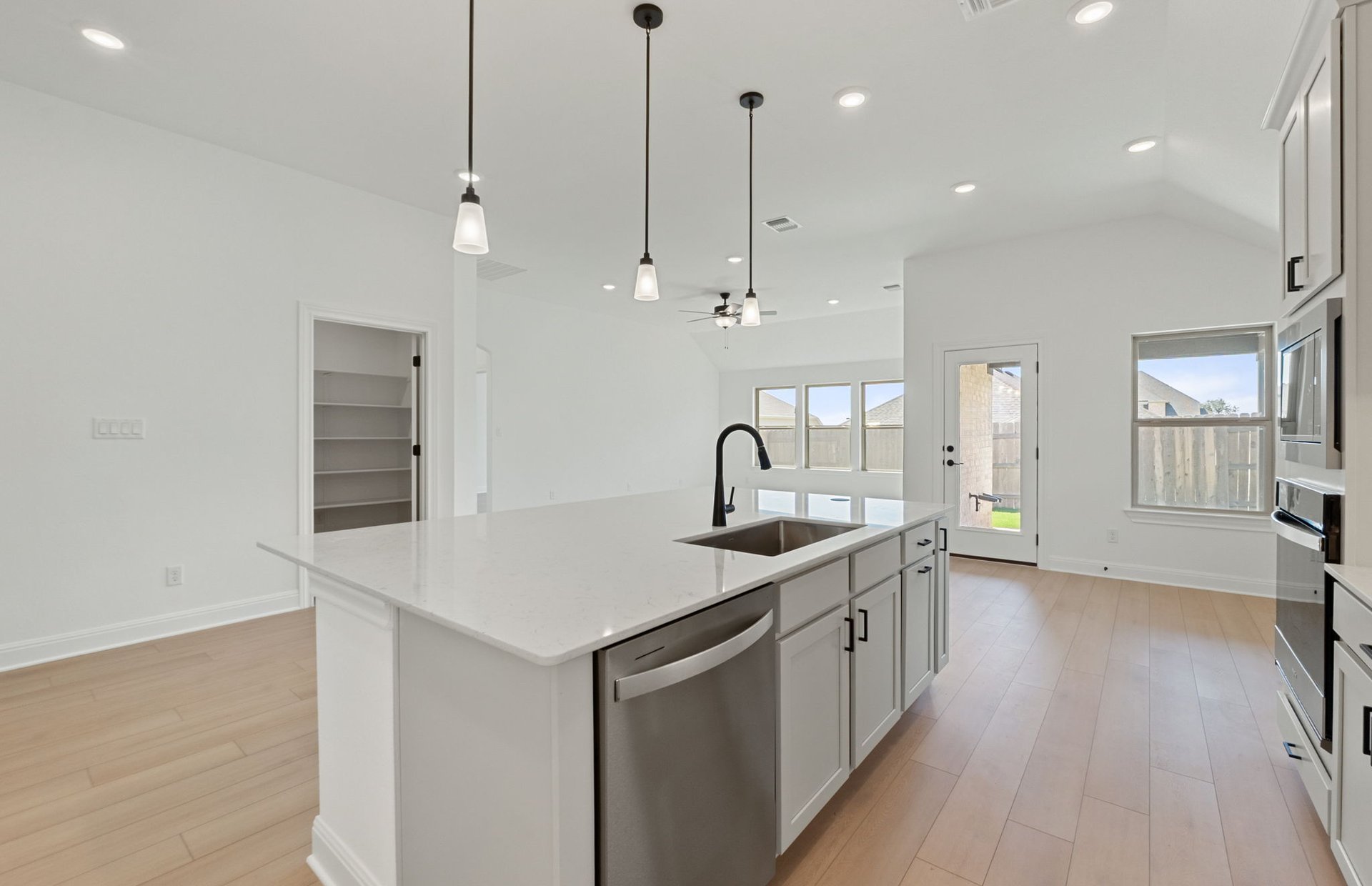 116 Elm Vw Drive Georgetown, TX 78628 - Photo 22 of 30 a kitchen with stainless steel appliances granite countertop a sink a stove and a wooden floors