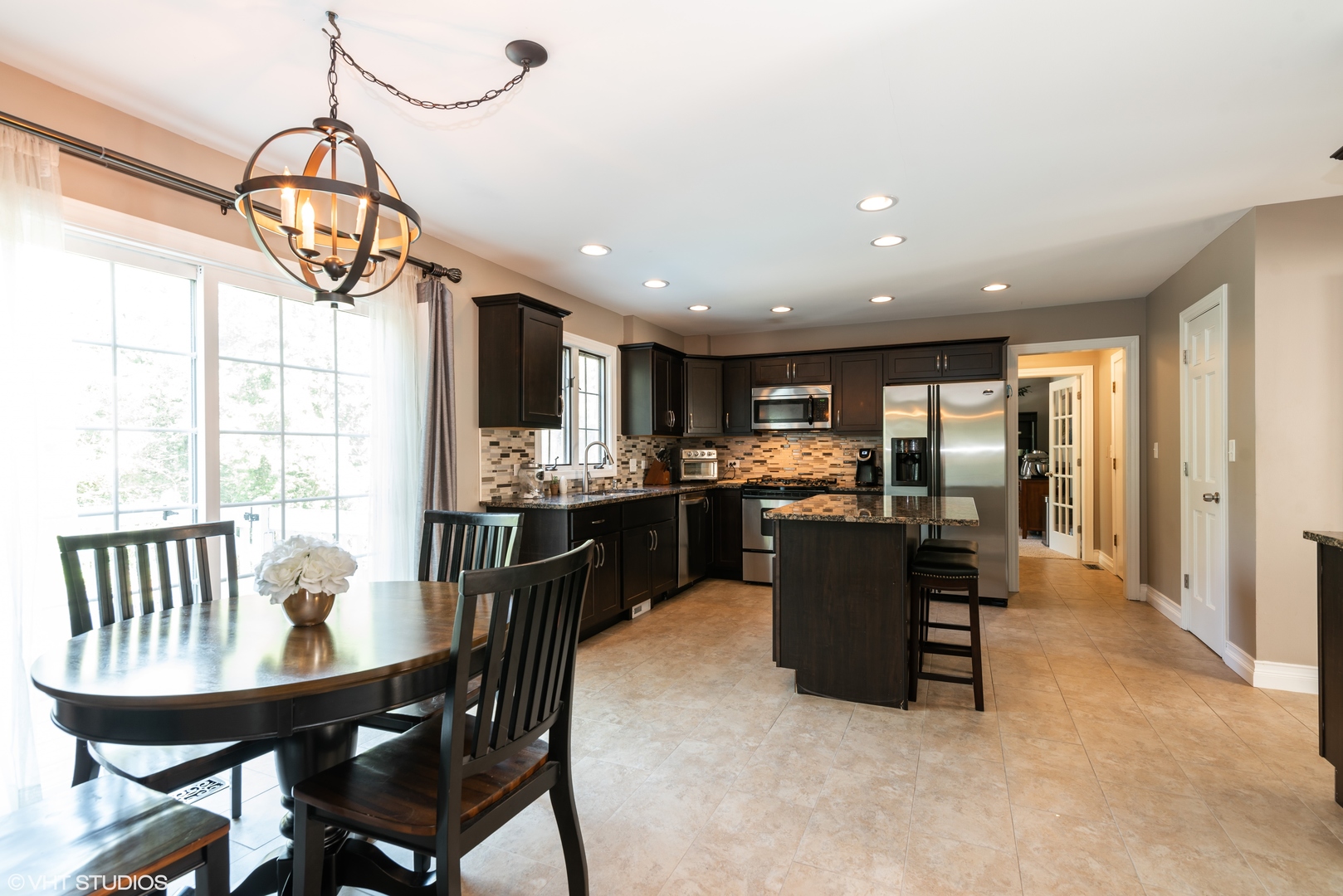 35W521 Parsons Road Dundee, IL 60102 - Photo 4 of 18 a kitchen with a dining table chairs stainless steel appliances and cabinets