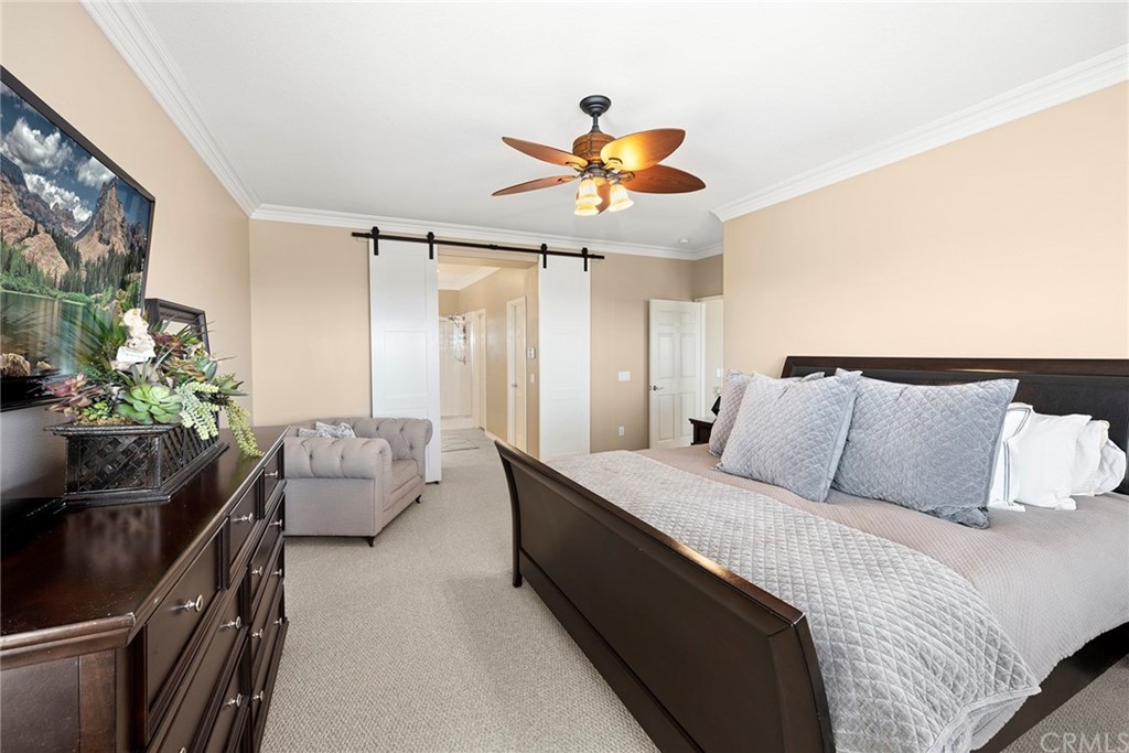 2442 Hawksfield Way Orange, CA 92867 - Photo 17 of 28 a bedroom with a bed and a chandelier