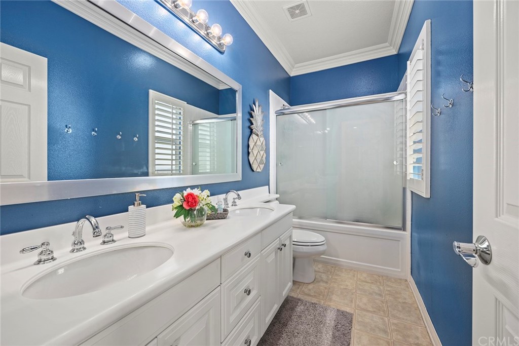 2442 Hawksfield Way Orange, CA 92867 - Photo 21 of 28 a bathroom with a double vanity sink toilet mirror and shower