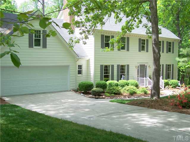 9321 Foxburrow Court Raleigh, NC 27613 - Photo 1 of 12 a front view of a house with a yard and potted plants