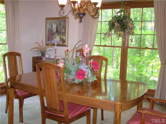 9321 Foxburrow Court Raleigh, NC 27613 - Photo 4 of 12 a view of a dining room with furniture window and outside view