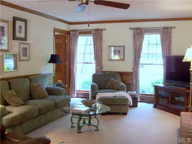 9321 Foxburrow Court Raleigh, NC 27613 - Photo 6 of 12 a living room with furniture and a flat screen tv