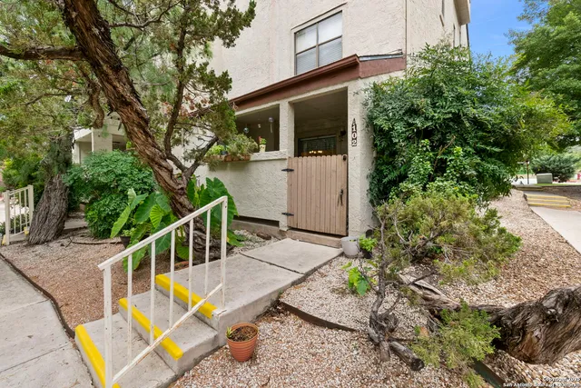 a view of a house with backyard and sitting area