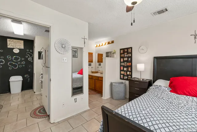a bedroom with a bed and cabinets
