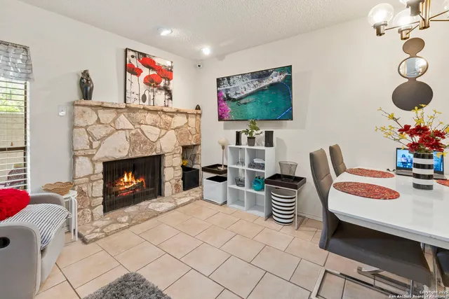 a living room with furniture and a fireplace