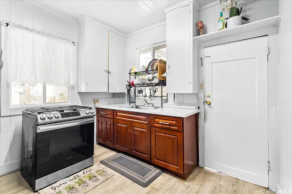 a kitchen with stainless steel appliances granite countertop a stove a sink and a microwave