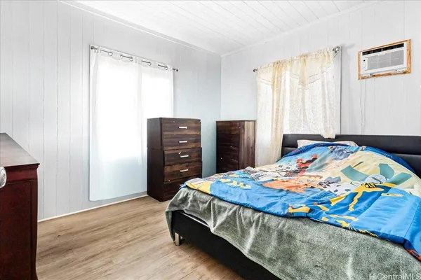 a bedroom with a bed and a dresser