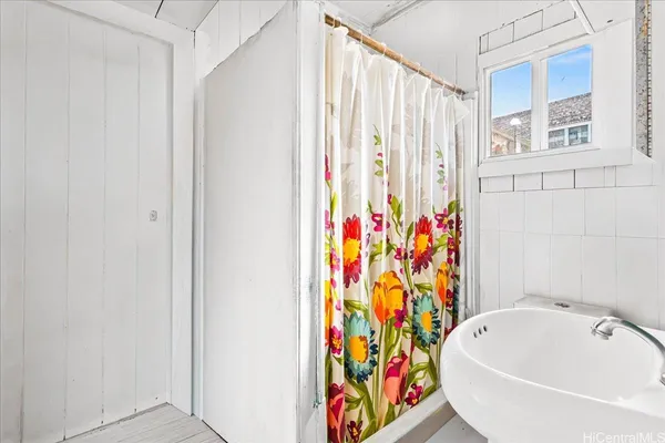 a bathroom with a shower curtain and a curtain