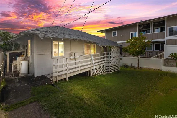 a view of a house with a backyard