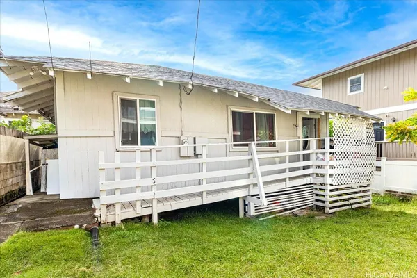 a view of a house with a yard and sitting area