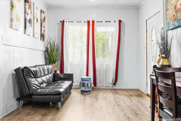 a living room with furniture gym equipment and a large window