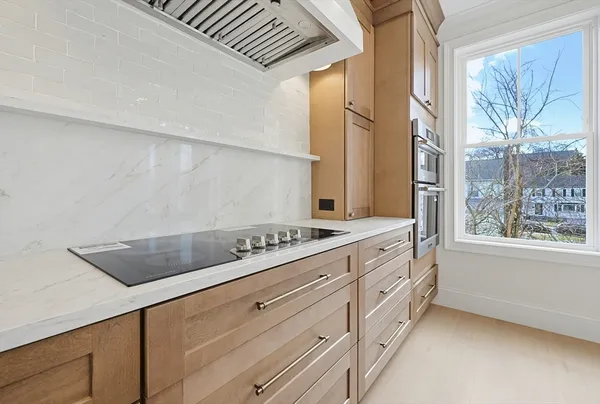 a kitchen with stainless steel appliances granite countertop a sink a stove and a refrigerator