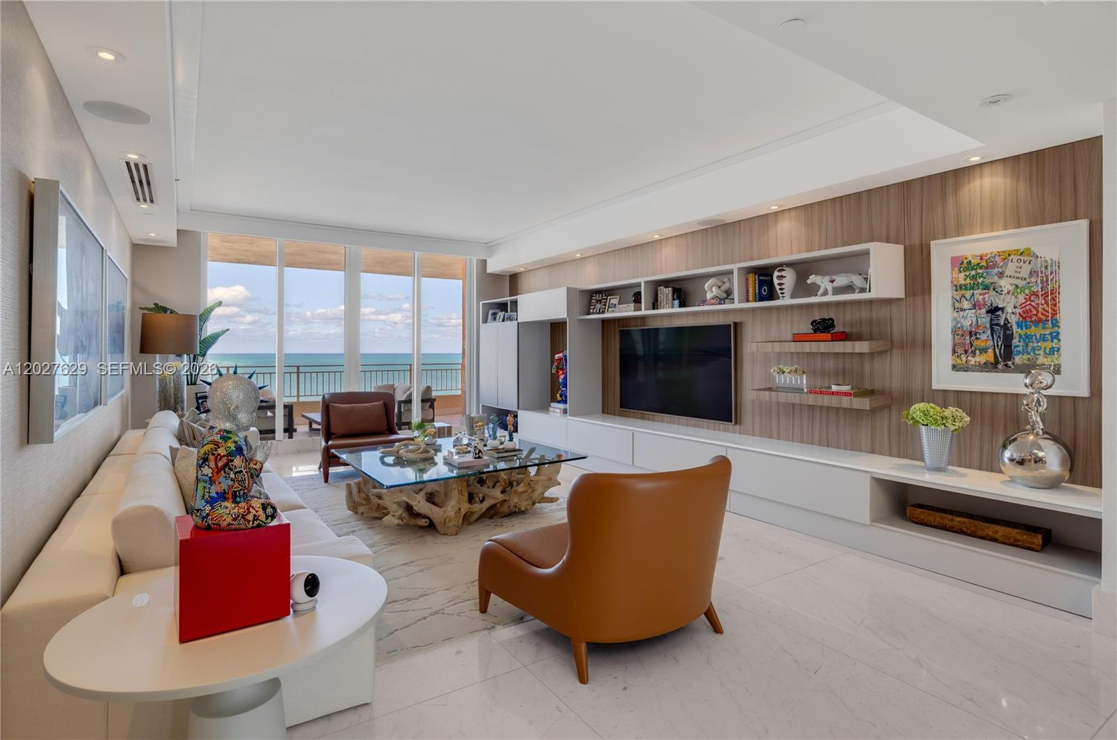 799 Crandon Boulevard, Unit PH8 Key Biscayne, FL 33149 - Photo 2 of 47 a living room with furniture and a flat screen tv