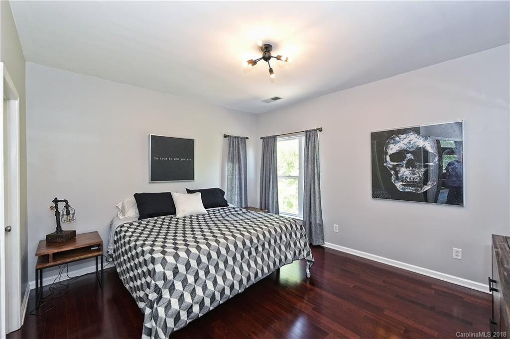 609 Raphael Place Charlotte, NC 28205 - Photo 21 of 36 a bedroom with a bed and a lamp on table