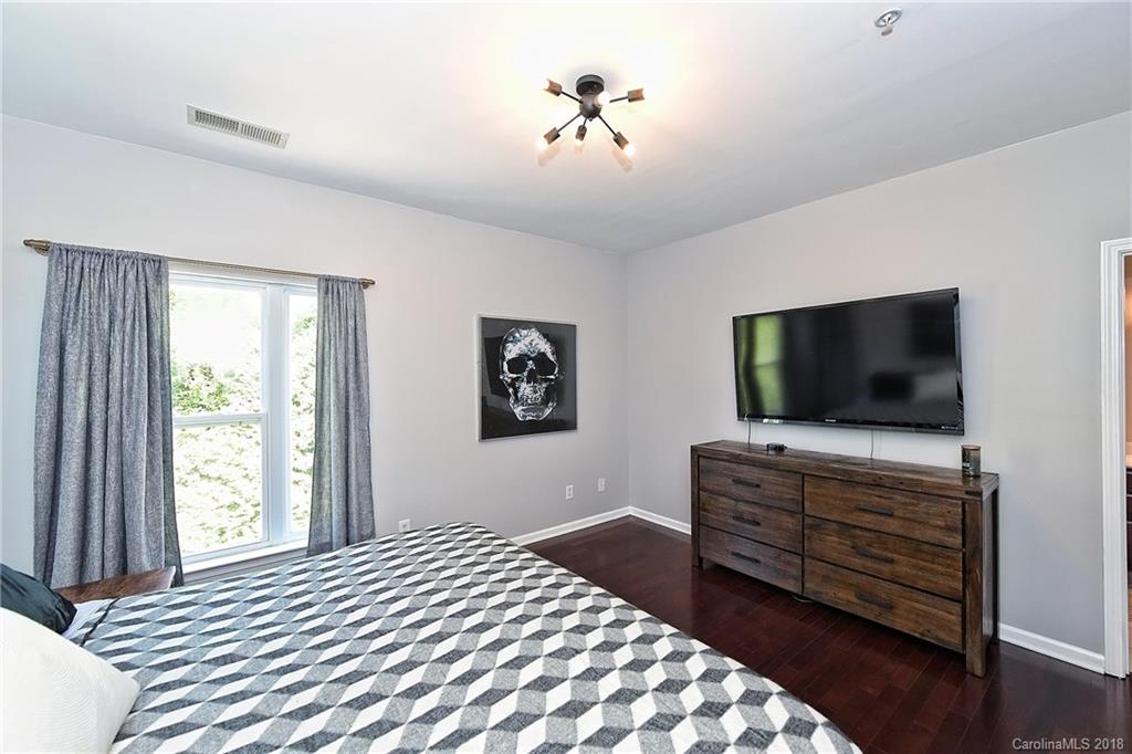 609 Raphael Place Charlotte, NC 28205 - Photo 22 of 36 a bedroom with a bed and a flat screen tv