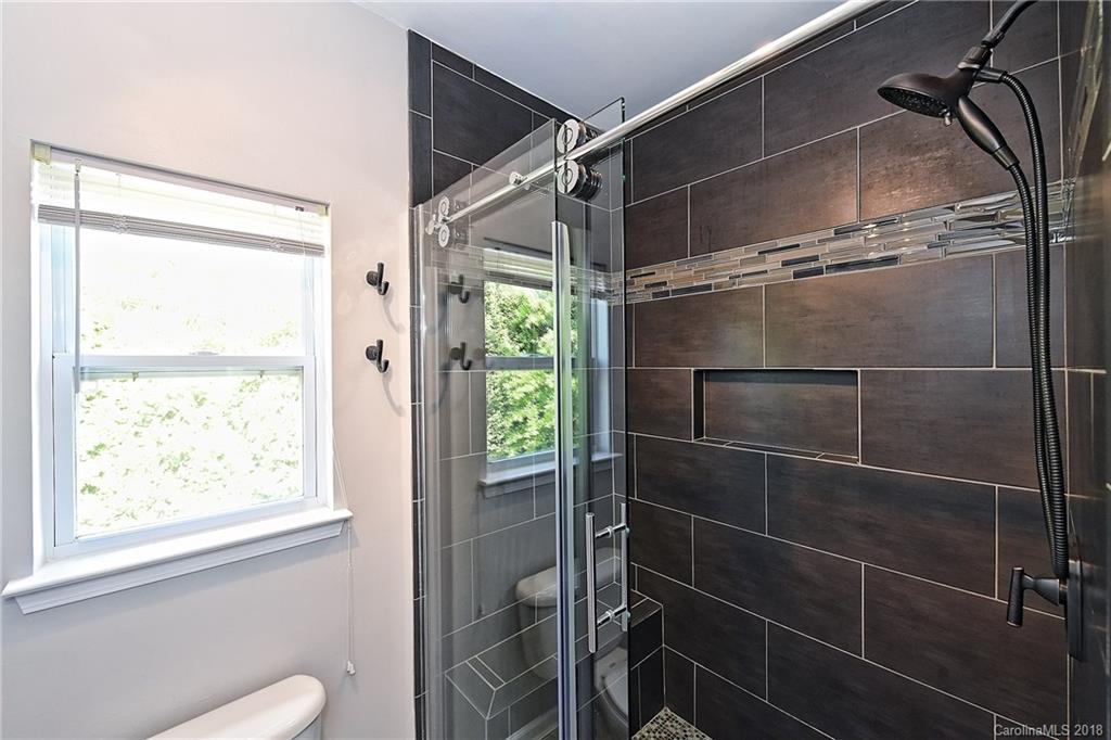609 Raphael Place Charlotte, NC 28205 - Photo 25 of 36 a bathroom with a shower and a window