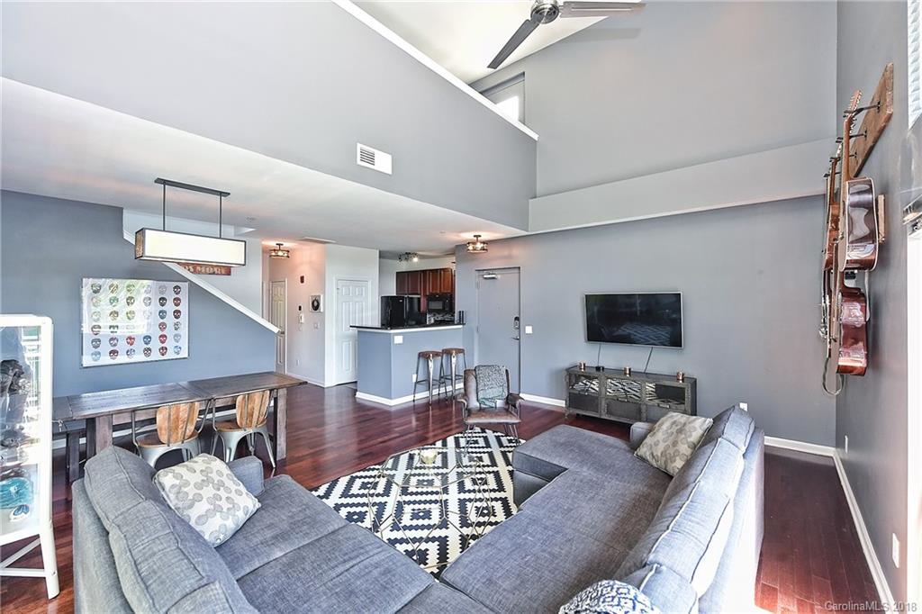 609 Raphael Place Charlotte, NC 28205 - Photo 5 of 36 a living room with furniture a flat screen tv and kitchen view