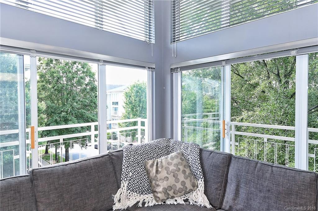 609 Raphael Place Charlotte, NC 28205 - Photo 7 of 36 a bed sitting in a bedroom next to a window