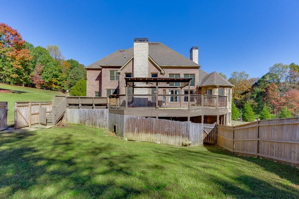 940 Chateau Forest Road Hoschton, GA 30548 - Photo 77 of 87 a view of a house with a yard and sitting area