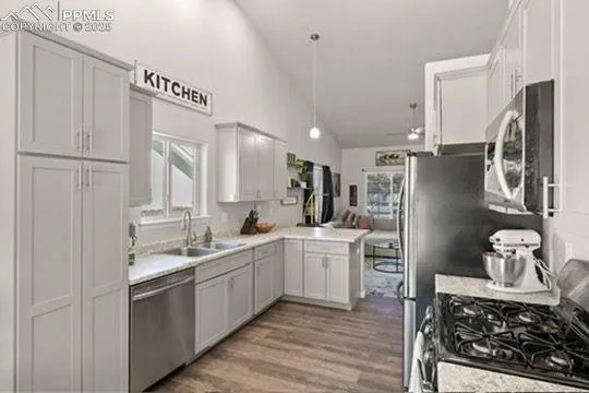 a kitchen with white cabinets and stainless steel appliances
