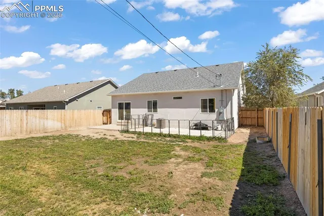 a front view of a house with a garden and yard