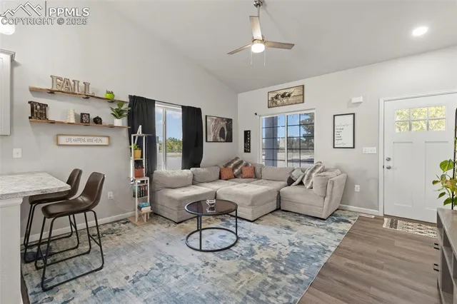 a living room with furniture and wooden floor