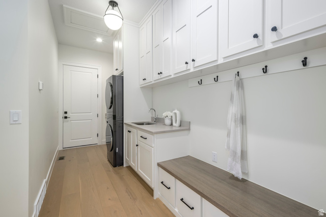 250 South Main Street, Unit 25 Alpine, UT 84004 - Photo 17 of 31 Mudroom with stacked washing machine and dryer and light wood-style flooring