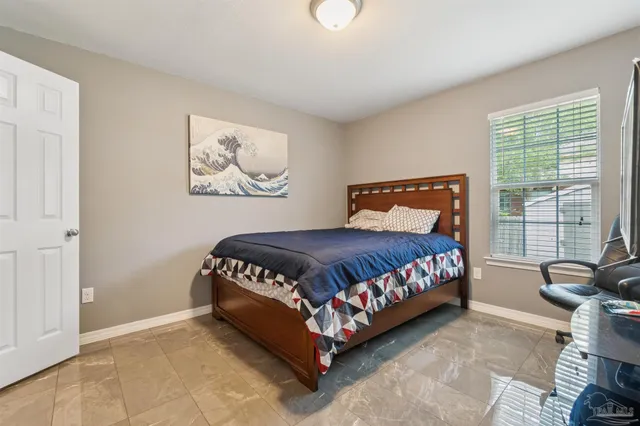 a bedroom with a bed and glass window