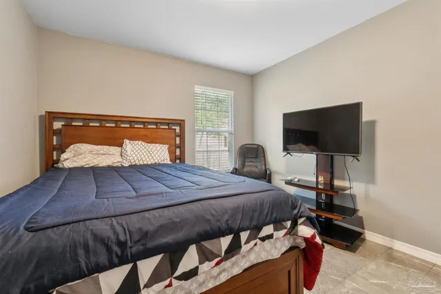 a bedroom with a bed and a flat screen tv