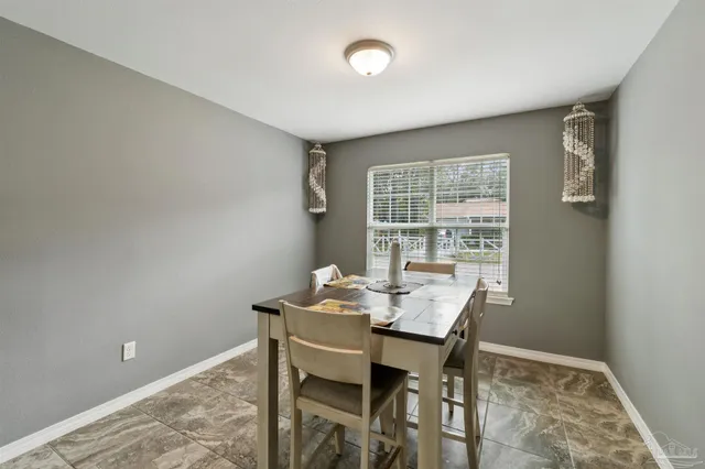 a view of a dining room with furniture and window