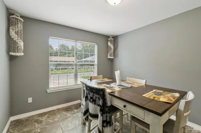 a view of a workspace with furniture and window