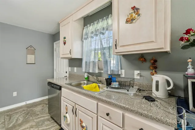 a kitchen with sink and window