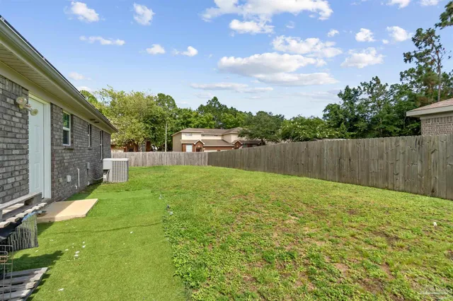 a view of a backyard with a garden and entertaining space