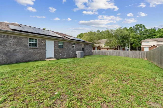a backyard of a house with lots of green space